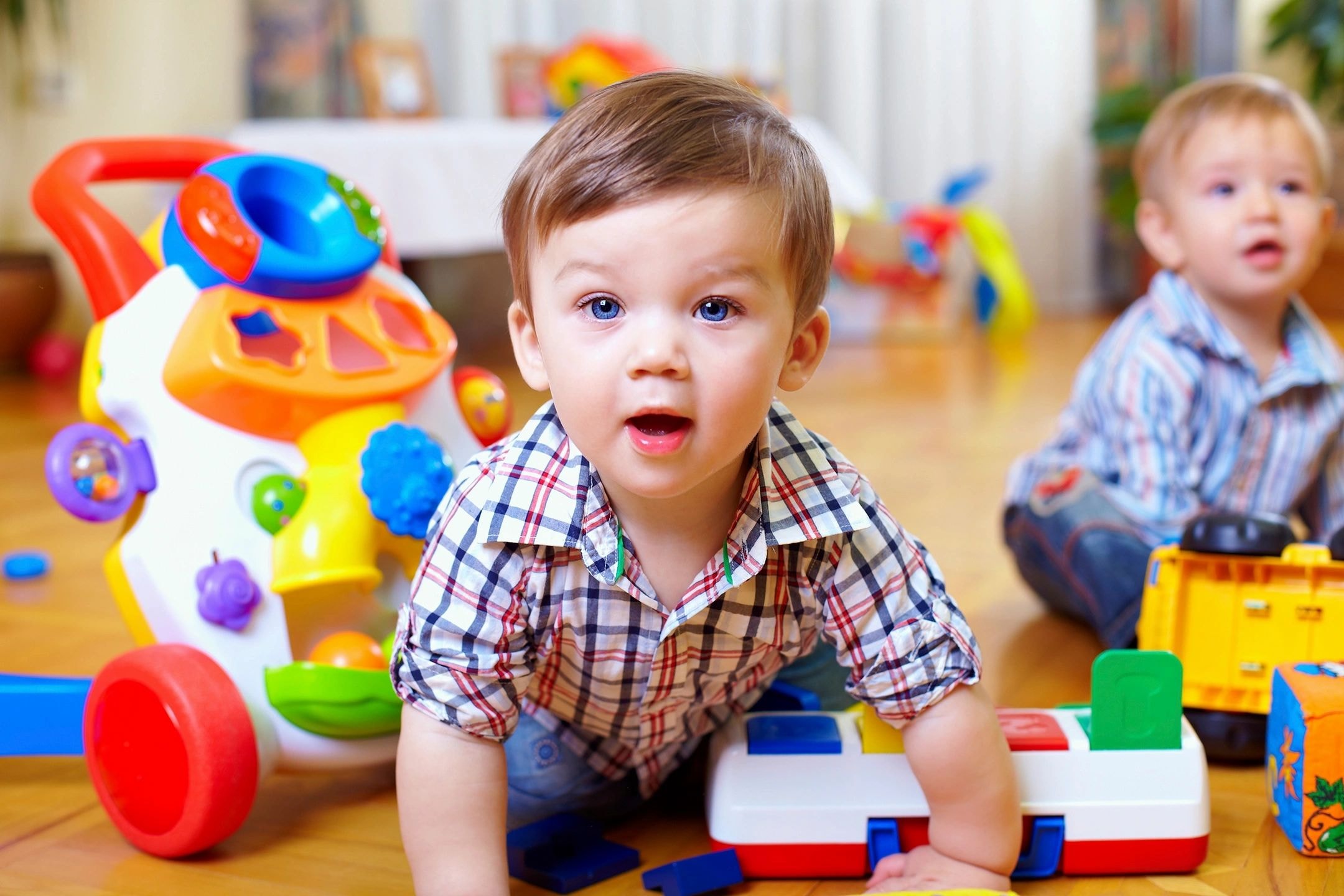 Toddler playing with toys on floor
